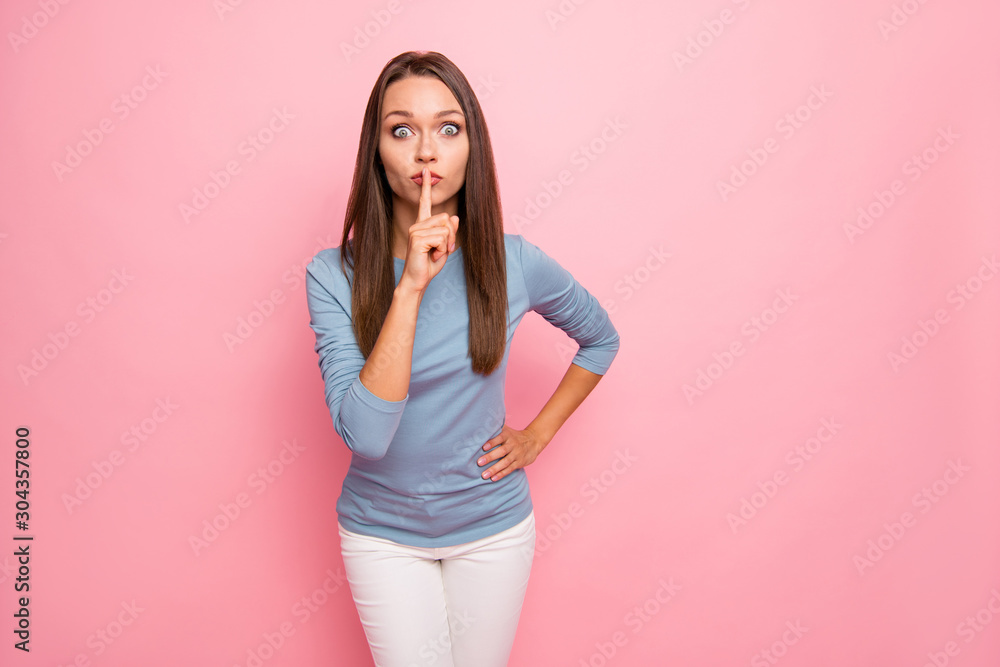 Photo of shocked astonished girl showing you shh sign touching lips with forefinger isolated pastel color background Photo of shocked astonished girl showing you shh sign touching lips with forefinger isolated pastel color background