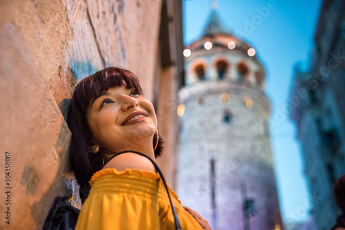 Photography Beautiful woman stands  in front of Galata tower