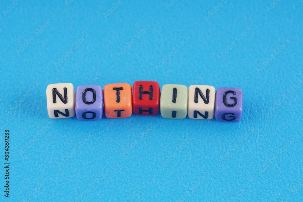 A word NOTHING made by a colourful cube beads alphabet over blue background. A word NOTHING made by a colourful cube beads alphabet over blue background.