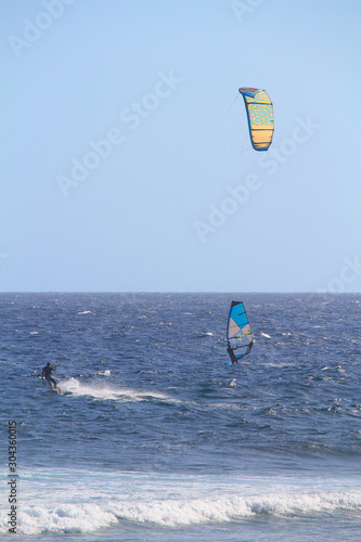 Kitesurfer and windsurfer at the Atlantic ocean photo