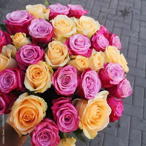 yellow and purple roses in a wedding bouquet