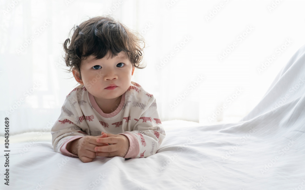 Portrait of little boy playing in the bedroom. Portrait of little boy playing in the bedroom.