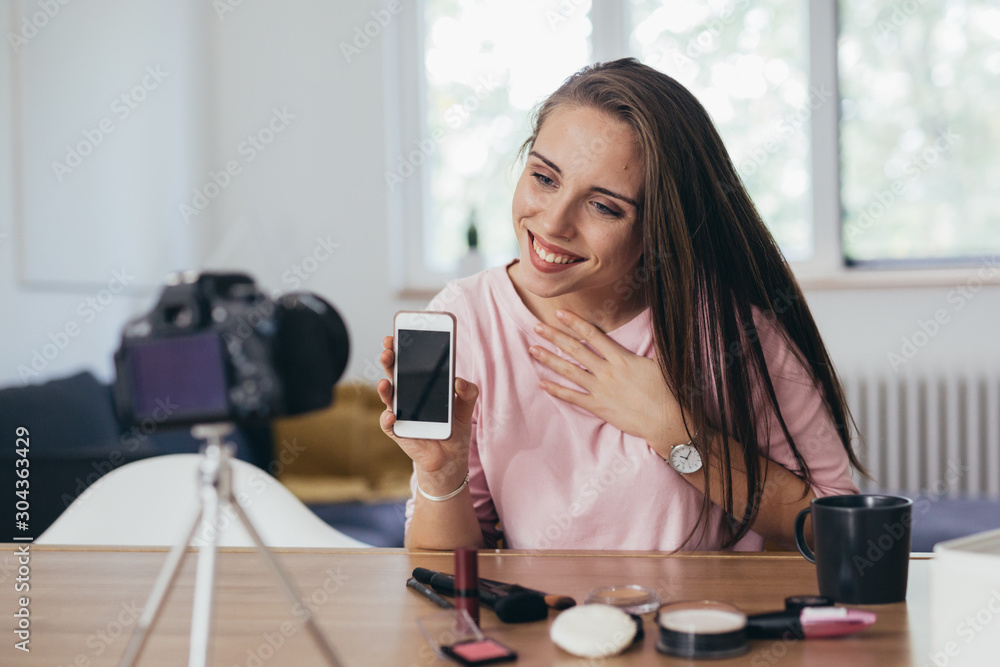 woman vlogger holding mobile phone woman vlogger holding mobile phone