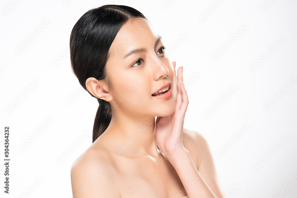 Beautiful young Asian woman touching soft cheek and smile with clean and fresh skin. Happiness and cheerful with, isolated on white background, Beauty and Cosmetics Concept,
