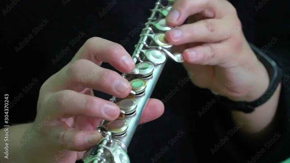 musician plays the flute. Musician's fingers close up. musician plays the flute. Musician's fingers close up.
