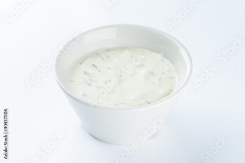 cream sauce with pickles in a bowl on a light background, mayonnaise