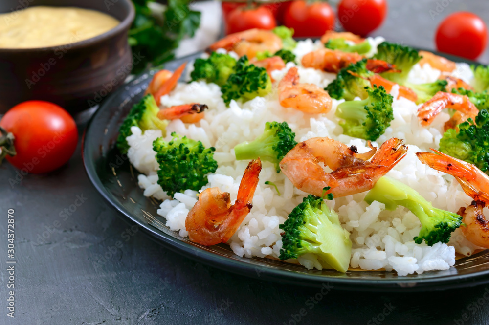 Rice with broccoli, shrimps and cream cheese sauce. Healthy and tasty food. Proper nutrition. Sports diet. Rice with broccoli, shrimps and cream cheese sauce. Healthy and tasty food. Proper nutrition. Sports diet.