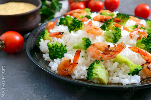 Rice with broccoli, shrimps and cream cheese sauce. Healthy and tasty food. Proper nutrition. Sports diet.