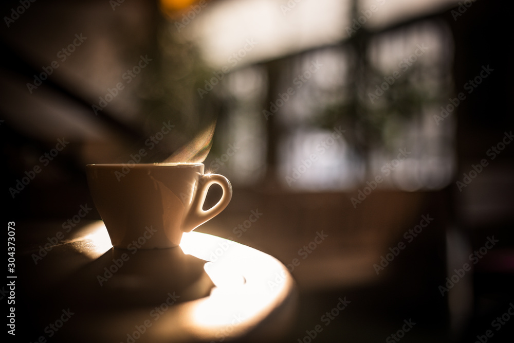 Steamy coffee cup in the sunlight - obrazy, fototapety, plakaty 