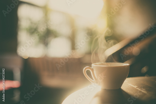 Obraz na plátne Steamy coffee cup in the sunlight