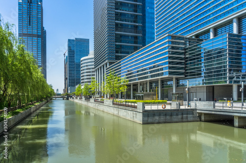 Fotografie, Obraz modern buildings at riverbank in shanghai.