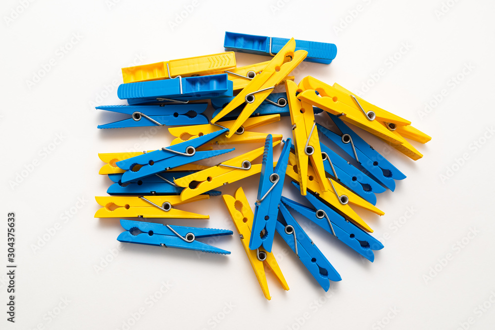 multi-colored plastic clothespins on white background multi-colored plastic clothespins on white background