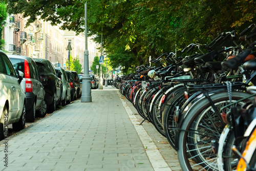bicycles and cars parked in amsterdam