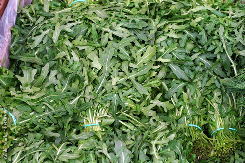 background of fresh arugula on the market  health food