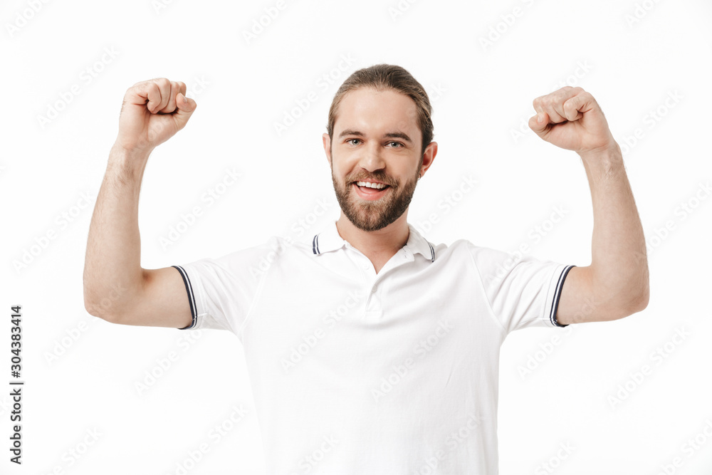 Fototapeta premium Happy young handsome bearded man make winner gesture.