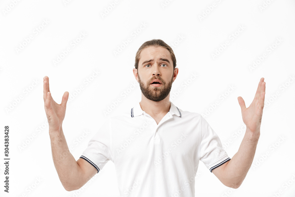 Handsome shocked man posing isolated over white wall background. Handsome shocked man posing isolated over white wall background.