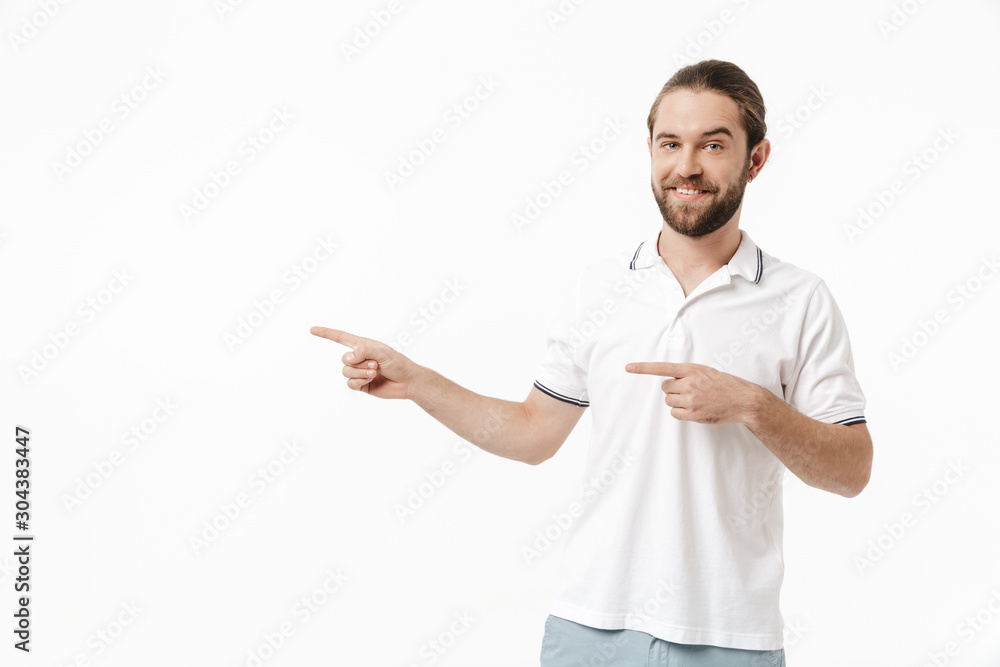 Bearded man posing isolated over white wall background pointing. Bearded man posing isolated over white wall background pointing.