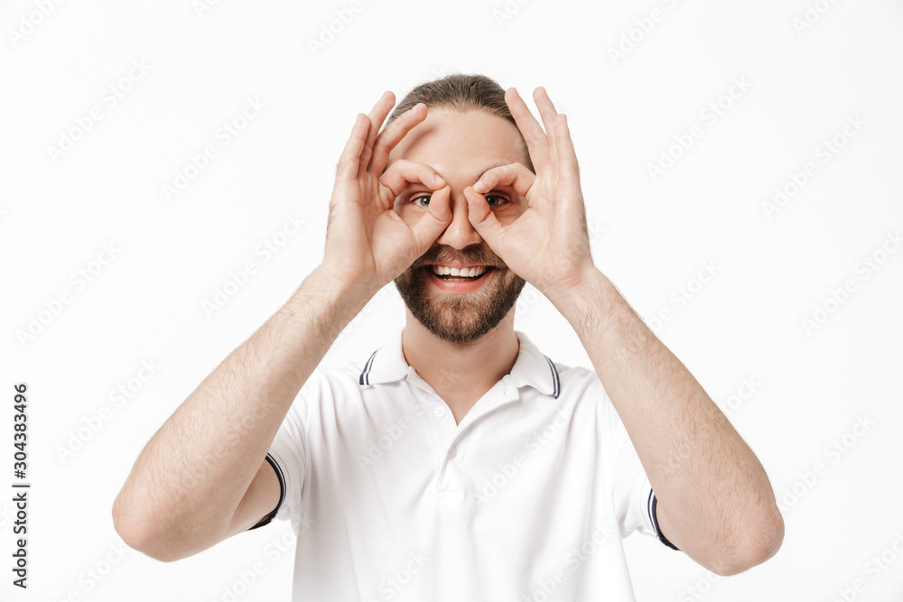 Attractive young bearded man wearing casual outfit standing
