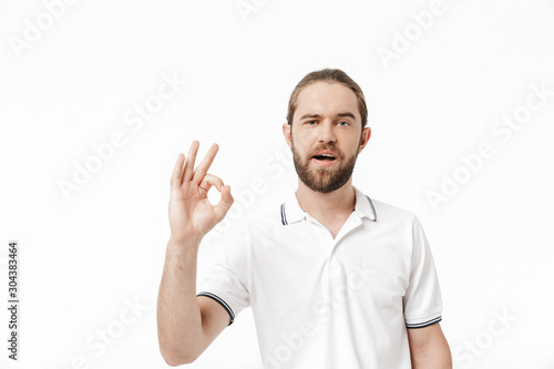 Attractive young bearded man wearing casual outfit standing