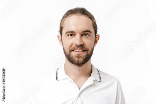 Handsome bearded man listening music with earphones.