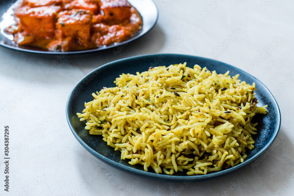 Indian Food Jeera Zira Rice Basmati Pilaf or Pilav with Paneer Butter Tikka Masala / Cheese Cottage Curry.