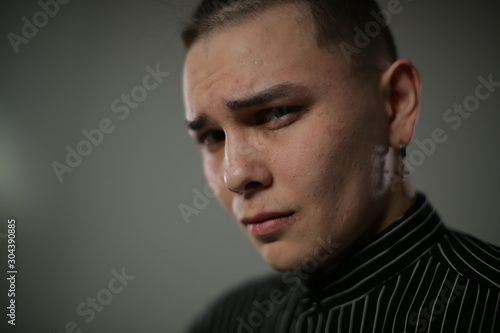 A sad young man with a sad expression on his face