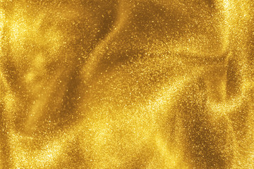 Abstract elegant, detailed gold glitter particles flow with shallow depth of field underwater. Holiday magic shimmering luxury background. Festive sparkles and lights. de-focused.
