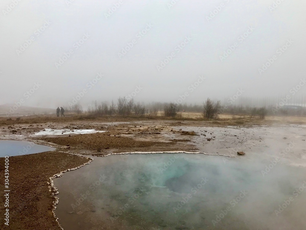 The Blesi Southern Pool, part of Haukadalur, the home of geysers and other geothermal features along the Golden Circle tourist route in southern Iceland on a foggy autumn afternoon