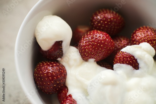 Fresh homemade strawberries for healthy breakfast with white yogurt and musli