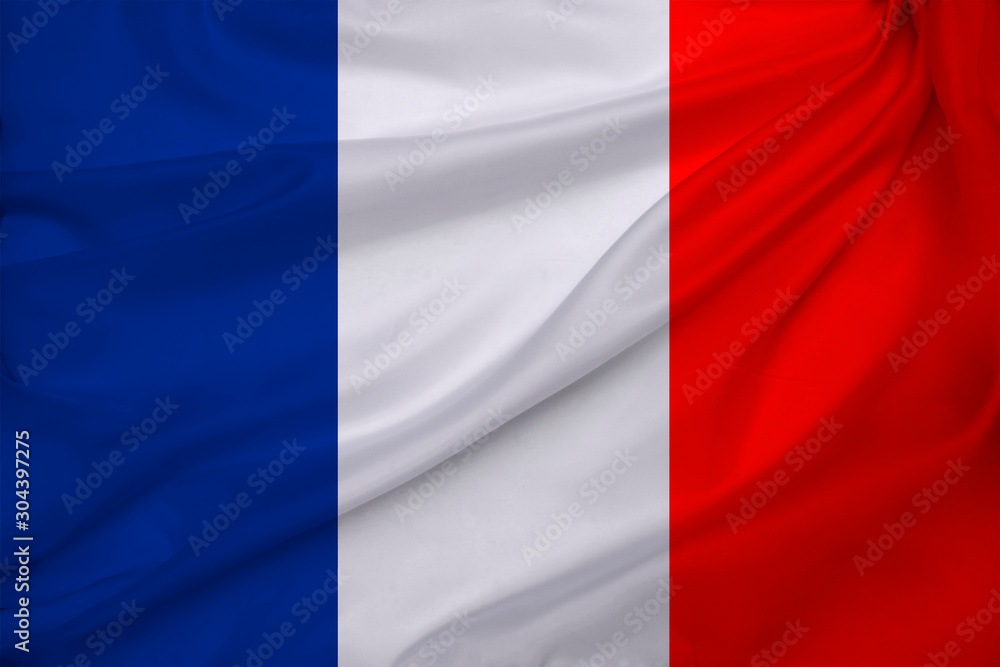 photo of the beautiful colored national flag of the modern state of France on textured fabric, concept of tourism, emigration, economics and politics, closeup