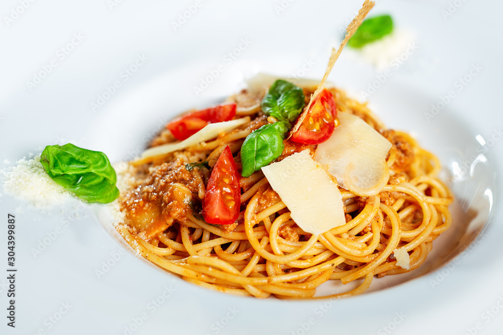 Spaghetti bolognese on a white plate.