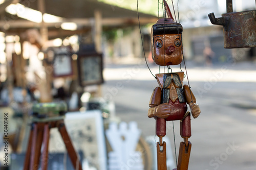 A handcrafted wooden Pinocchio in a street flea market