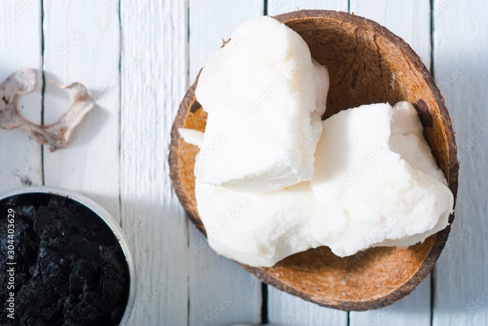 organic skin care butters from, shea, macadamia nut, coffee, mango, and cosmetic clay, mud on white wooden organic skin care butters from, shea, macadamia nut, coffee, mango, and cosmetic clay, mud on white wooden
