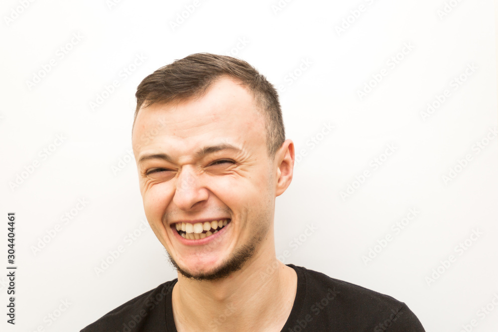 Fototapeta premium emotion joy, young man on a white background, human emoji