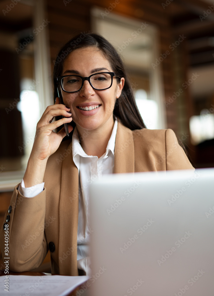 Beautiful Young Woman is working on her Tablet in the Laptop Beautiful Young Woman is working on her Tablet in the Laptop