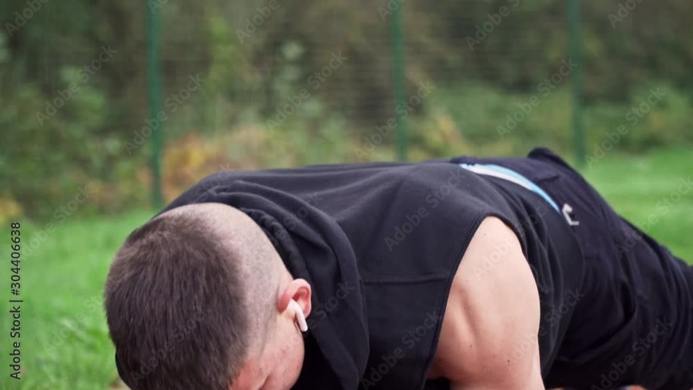 4k resolution closeup tilt movement video of young fit man doing plank exercise in the morning outdoor on the running race track 4k resolution closeup tilt movement video of young fit man doing plank exercise in the morning outdoor on the running race track