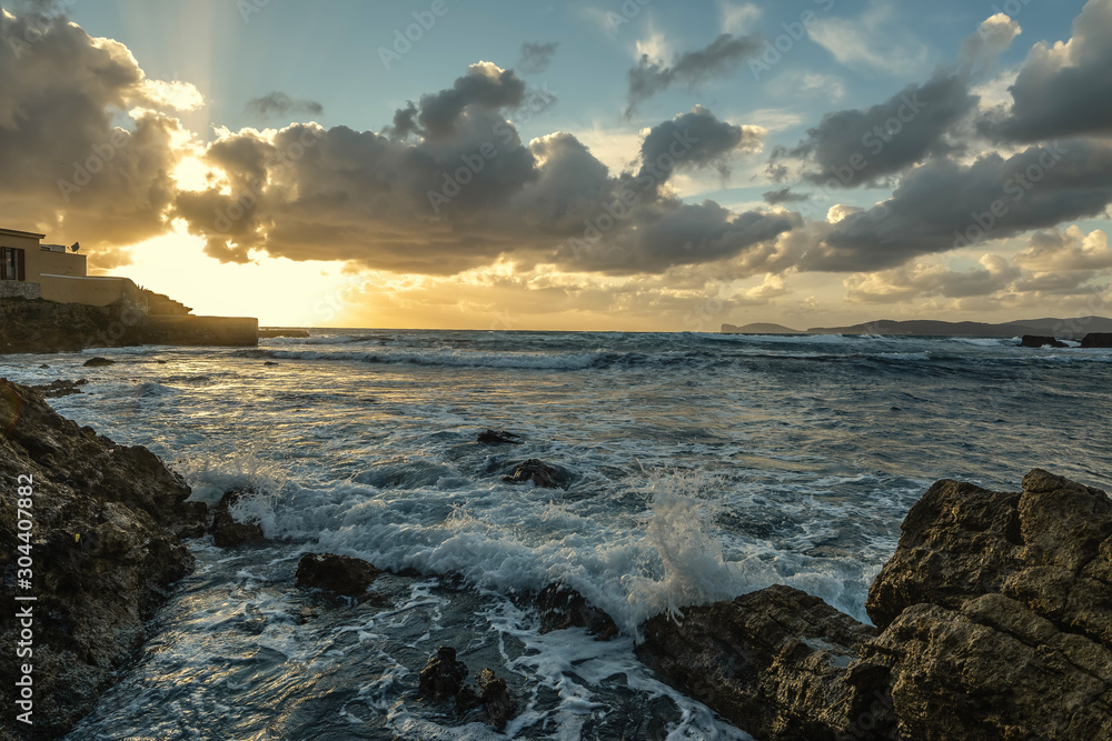 Rough sea in Alghero coast at sunset