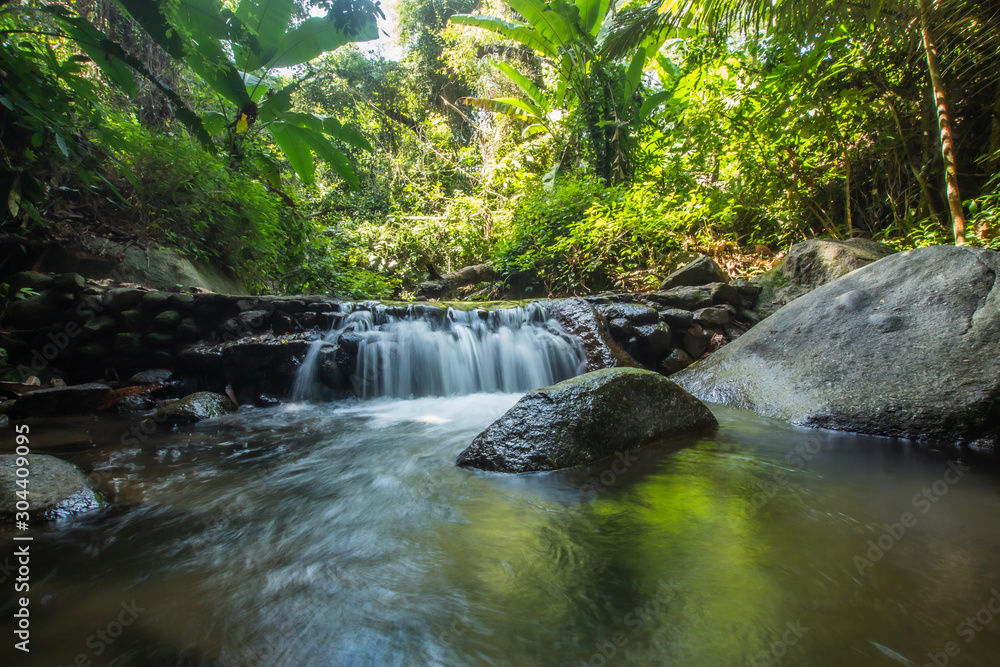 © Stock.Foto.Touch - Kathu Waterfall in the tropical forest area In Asia, suitable for walks, nature walks and hiking, adventure photography Of the national park Phuket Thailand,Suitable for travel and leisure.