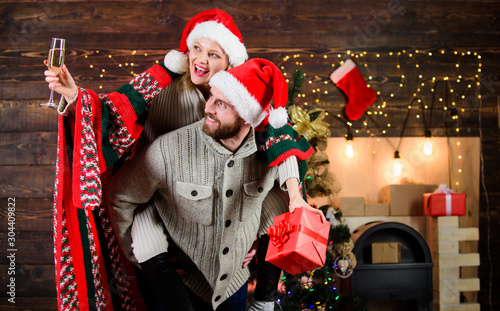 woman and man love xmas. greeting time. Couple feeling cozy. merry christmas. Family drink champagne. happy new year. Holiday celebration. couple in love santa hat. Time for presents