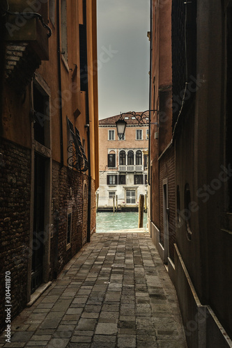 Narrow alley by Venice s Grand Canal