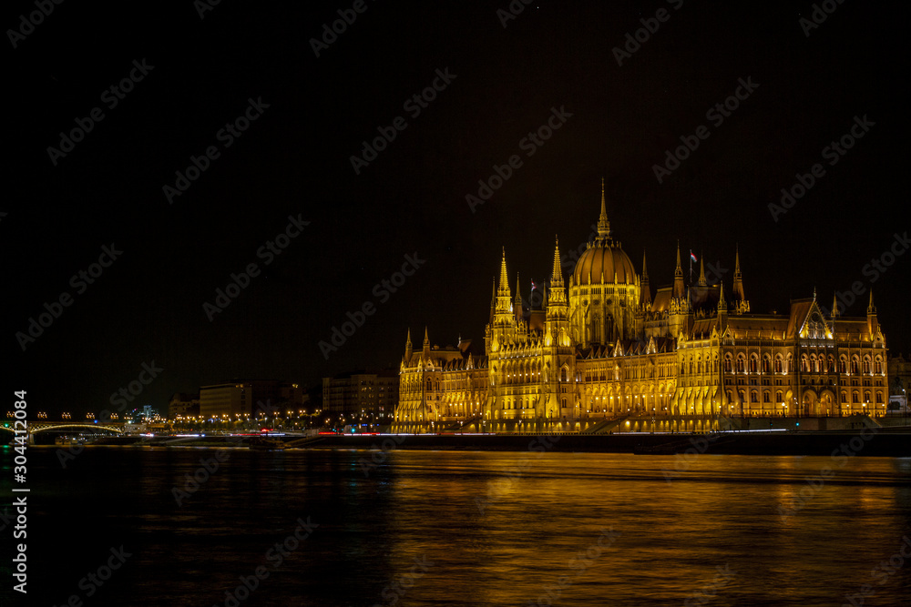 View on the The Hungarian Parliament Building, beside the Danube River. European travel. Night scene. Budapest. Hungarian landmarks.