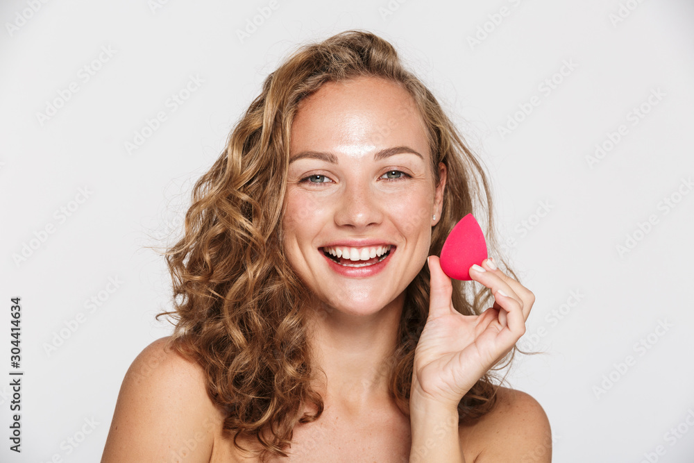Image of pleased half-naked woman laughing and holding facial sponge Image of pleased half-naked woman laughing and holding facial sponge