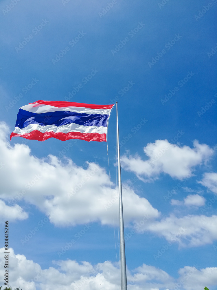 Image of waving Thai flag of Thailand with wind on blue sky background