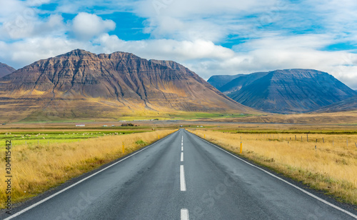 Iceland road landscape. Clouds and ocean on the horizon. Famous tourist attraction