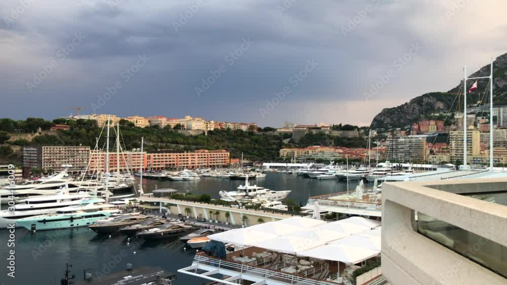 Port Hercules with big yachts and boats on a cloudy day with tall buildings, popular tourist location, luxury lifestyle Port Hercules with big yachts and boats on a cloudy day with tall buildings, popular tourist location, luxury lifestyle
