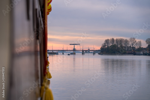 Traffic drawbrigde over the water during a sunset on the lakes of the Netherlands photo