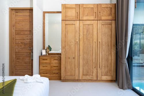 spacious and modern bedroom with wooden wardrobe photo