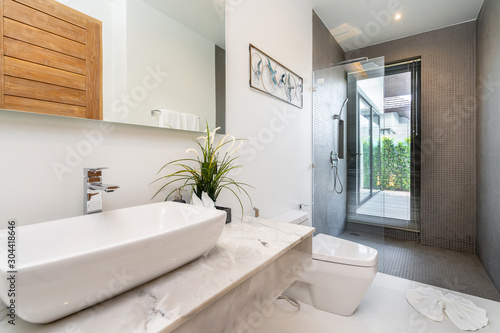 Modern bathroom  sinkm shower  and bathtub in luxury villa