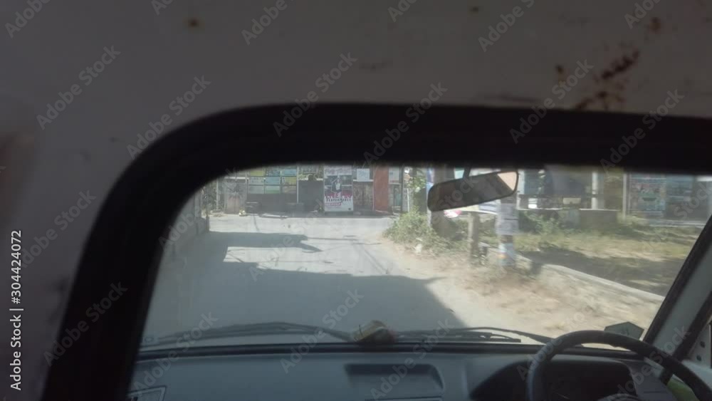 Filming true window of small truck in Bali Indonesia, Nusa Lembongan rural island. Transportation filmed with hand held camera while balinese peoples driving. Filming true window of small truck in Bali Indonesia, Nusa Lembongan rural island. Transportation filmed with hand held camera while balinese peoples driving.