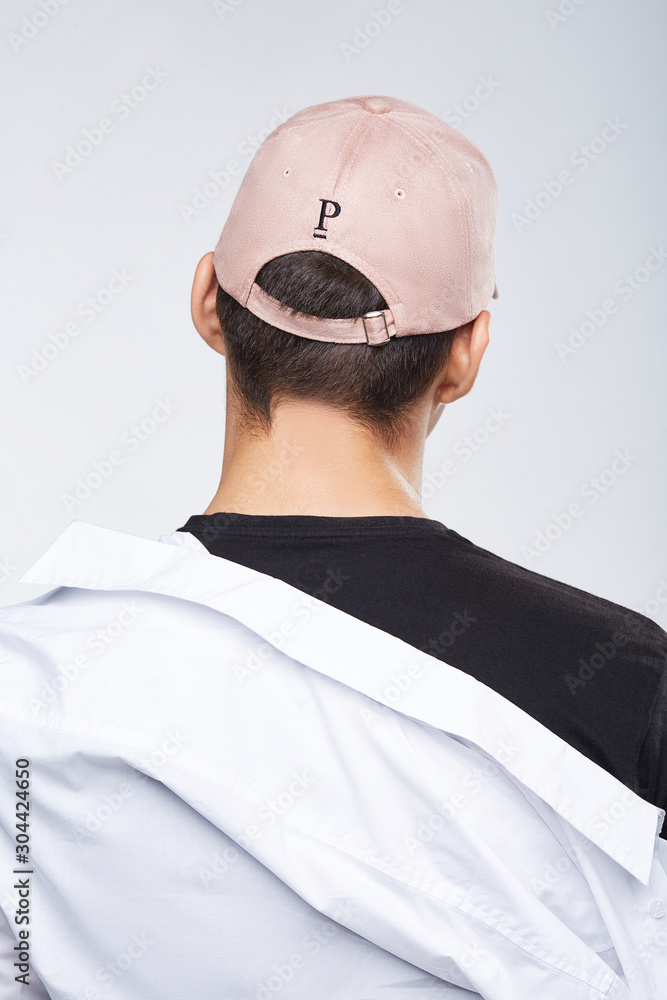 wearing pink baseball cap with letter P 